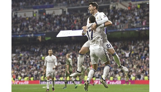 Real Madridu2019s midfielder Lucas Vazquez (L) and Real Madridu2019s forward Alvaro Morata celebrate after scoring a goal against Legia Warszawa.
