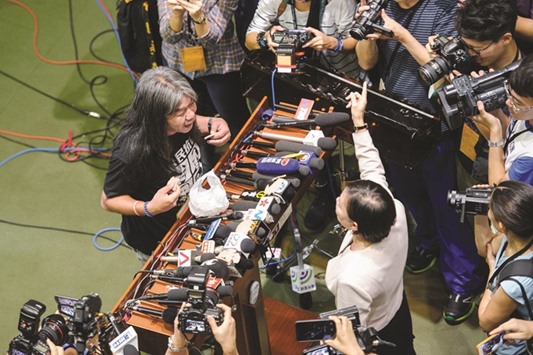 Pro-independence lawmaker Leung Kwok-hung (left), known as Long Hair, argues with pro-Beijing lawmaker Priscilla Leung Mei-fun after members of the latter group walked out of the main chambers to block the second swearing-in of pro-democracy lawmakers u2013 whose initial oaths from October 12 were invalidated u2013 at the Legislative Council in Hong Kong yesterday.