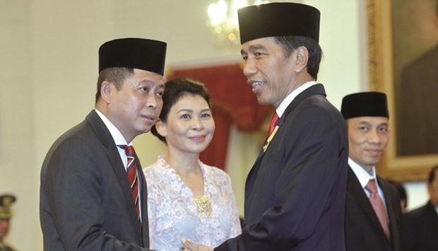 Indonesiau2019s President Joko Widodo congratulating former transportation minister Ignasius Jonan, left, after the latter was sworn in as the new energy and mineral resources minister, during a ceremony at the presidential palace in Jakarta last Friday.