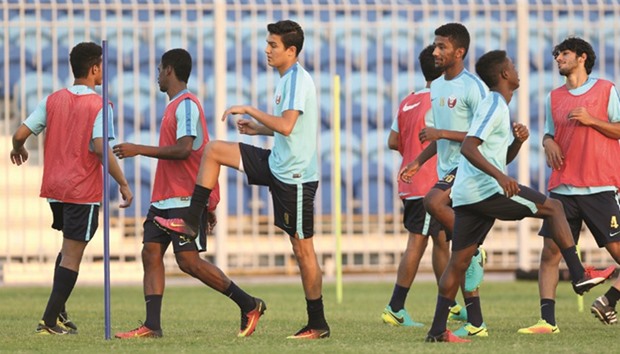 Qatar players warm up during a training session on the eve of their AFC U-19 Championship match against Japan in Bahrain yesterday. PICTURES: Fadi al-Assaad