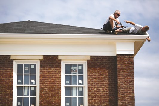 Contractors install gutters on a house under construction in the Norton Commons subdivision of Louisville, Kentucky. Residential starts declined 9% to a 1.05mn annualised rate, the lowest since March 2015, a Commerce Department report showed in Washington yesterday.