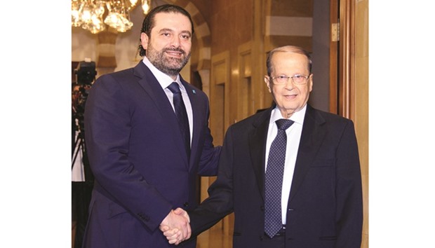 Lebanonu2019s former prime minister Saad Hariri greets former general Michel Aoun following a press conference in Beirut yesterday.