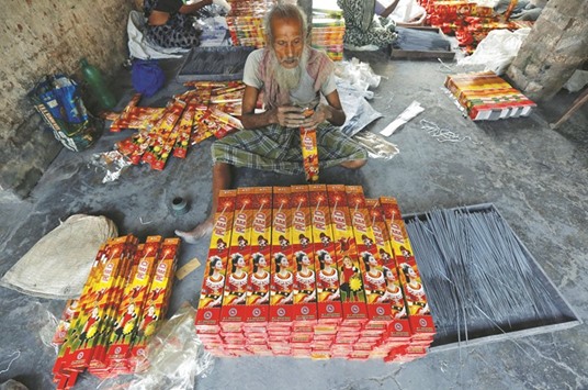 A man packs sparklers for sale at a factory ahead of Diwali on the outskirts of Kolkata yesterday. A huge explosion set off by a blaze at a fireworks factory in Sivakasi killed eight people yesterday.