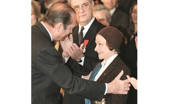 This file photo taken on March 3, 1998 shows then-French president Jacques Chirac awarding Chauvire with the National Order of Merit at the Elysee Palace in Paris.