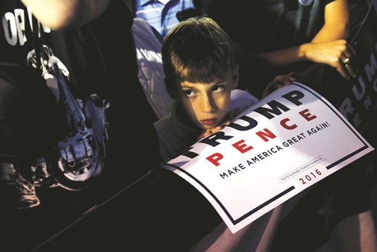 A boy with a campaign poster is seen at the Trump rally in Delaware.