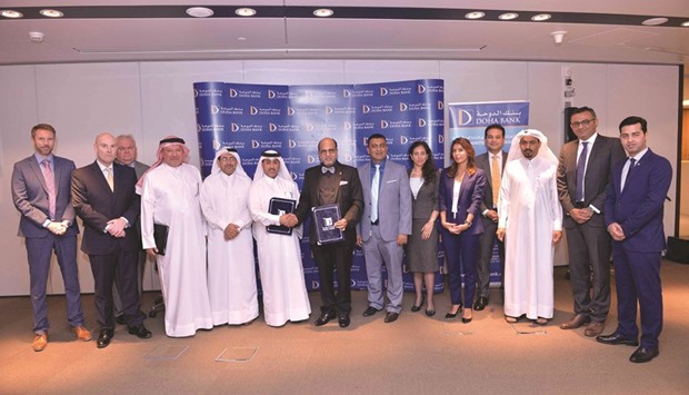 Doha Bank CEO Dr R Seetharaman and QFBA CEO Dr Abdulaziz al-Horr shake hands after the MoU signing ceremony.