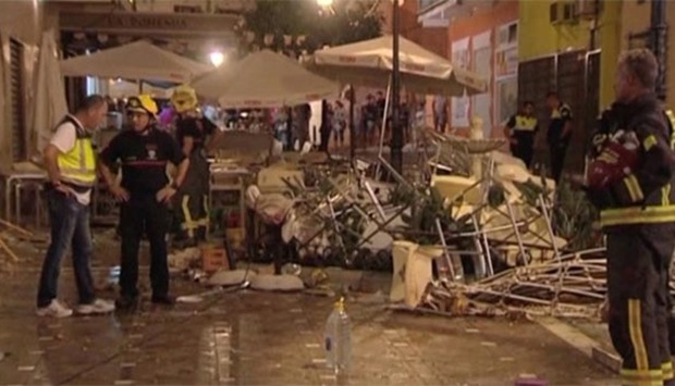 Police and rescue services are pictured at the scene after a gas cylinder exploded in a cafe in Velez-Malaga on Saturday.