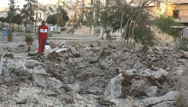 A Syrian hospital staff member inspecting the damage at the site of a medical facility after it was  hit by Syrian regime barrel bombs yesterday in the rebel-held neighbourhood of al-Sakhour, in the northern city of Aleppo.