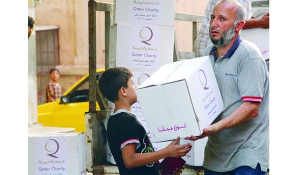 A boy receiving a box from a QC volunteer.