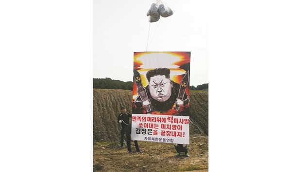 This handout photo released by North Korean defectors group, Fighters For Free North Korea (FFNK), yesterday shows a big banner with a caricature of North Korean leader Kim Jong-Un as South Korean activists launch large balloons containing anti-Pyongyang leaflets into the air at a field near the Demilitarised Zone dividing the two Koreas, in Paju. The banner reads: u2018Down with maniac Kim Jong-Un who fires nuclear missiles over our headsu2019. Activists floated hundreds of thousands of leaflets across the border into North Korea yesterday.