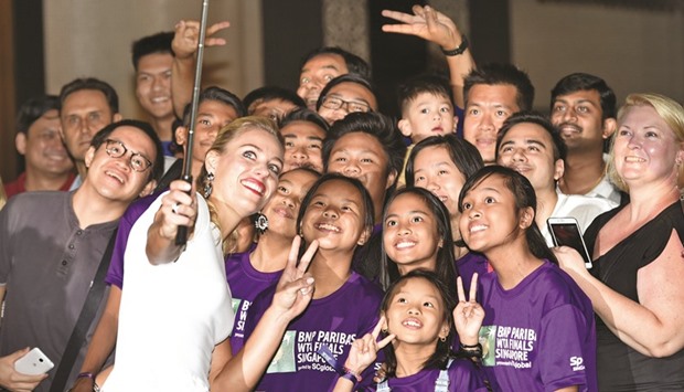 Angelique Kerber of Germany takes a selfie with fans during the official draw ceremony prior to the WTA Finals at Marina Bay Sands in Singapore yesterday. (AFP)
