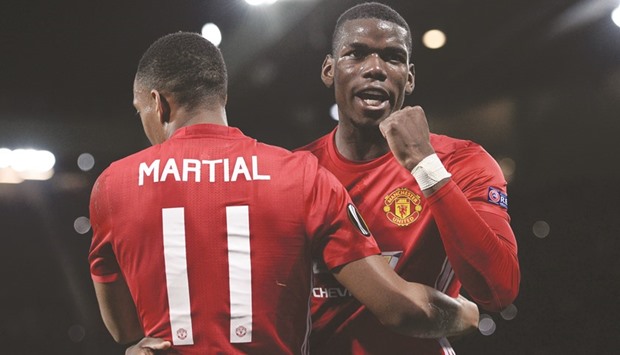 Manchester Unitedu2019s Anthony Martial (L) embraces Paul Pogba (R) as he celebrates after scoring their second goal.