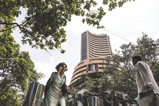 Pedestrians walk past the Bombay Stock Exchange in Mumbai. Indiau2019s attack on terrorist camps in Pakistan introduces a sobering note for financial markets closing out a blockbuster quarter.