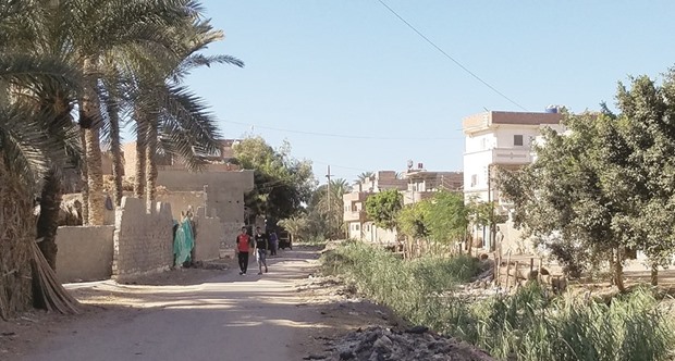 UNCERTAIN FUTURE: Boys walk to school in Rashid, Egypt, where some families and friends encourage youths to migrate to Italy. Those who survive the dangerous journey send money home to build houses.