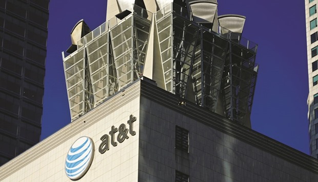 An AT&T logo and communication equipment is seen on a building in Los Angeles. AT&T has reached an agreement in principle to buy Time Warner for about $85bn, sources said on Friday, paving the way for what would be the biggest deal in the world this year.