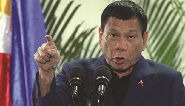 Philippine President Rodrigo Duterte interacts with reporters during a news conference upon his arrival from a four-day state visit in China at the Davao International Airport. China will provide $9bn in soft loans, including a $3bn credit line with the Bank of China, while economic deals including investments would yield $15bn, a top government official said.