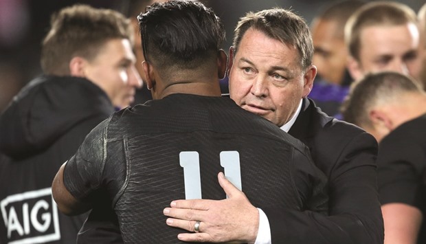 New Zealand All Blacks coach Steve Hansen (right) hugs player Julian Savea after the third rugby Bledisloe Cup Test against the Australia Wallabies at Eden Park in Auckland yesterday. (AFP)