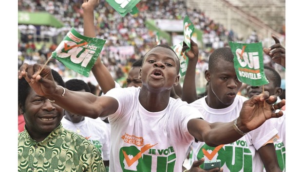 Supporters hold placards reading u2018Referendum October 30, 2016 u2014 I vote yesu2019 during a rally organised by Ivory Coastu2019s President Alassane Ouattara at the Felix Houphouet-Boigny stadium, in Abidjan.