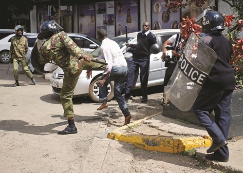 Kenyan policemen beat a protester during clashes in Nairobi in May 2016.