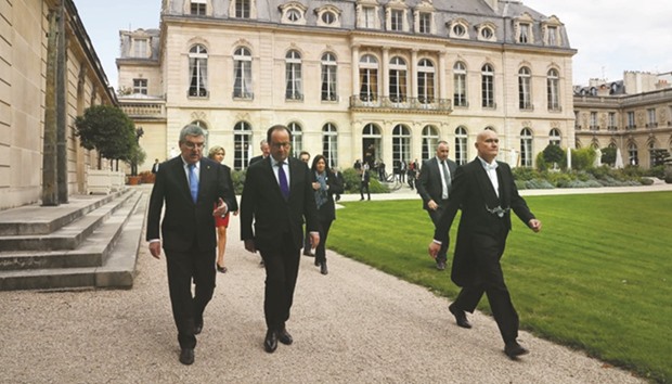 Franceu2019s President Francois Hollande (C) and International Olympic Committee president Thomas Bach (L) leave from the Elysee Palace in Paris yesterday. (AFP)