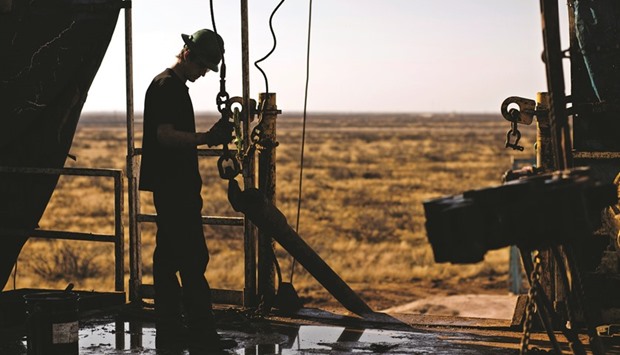 A worker waits to connect a drill bit at a rig in the Permian basin outside of Midland, Texas, US (file). A cohort of shale producers ready to boost output when prices rise could cap any recovery at about $60 a barrel for the next couple of years, regardless of any Opec moves to cut production.