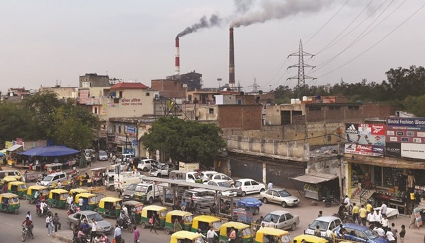Smoke billowing from two stacks at the coal-based Badarpur Thermal Station in New Delhi. India, the worldu2019s third biggest carbon emitter, ratified the Paris agreement on climate change yesterday, on the birthday of the countryu2019s independence leader Mahatma Gandhi.