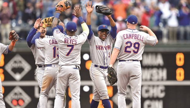 New York Mets right fielder Curtis Granderson (centre) celebrates with left fielder Michael Confort, shortstop Asdrubal Cabrera, third baseman Jose Reyes and first baseman Eric Campbell after clinching a wild-card playoff berth after a game against the Philadelphia Phillies at Citizens Bank Park. PICTURE: USA TODAY Sports