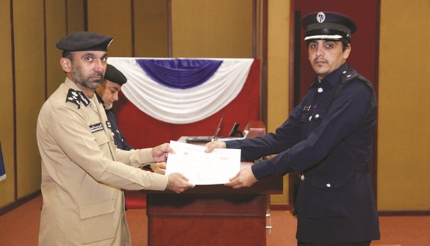 Graduates receiving their certificates at a ceremony at the Police Training Institute.