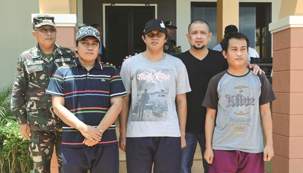Sulu Governor Sakur Tan (second right) stands beside Indonesian sailors Edi Suryono, Mohamed Mabrur Dahri and Ferry Arifin in the town of Jolo on the southern island of Mindanao.