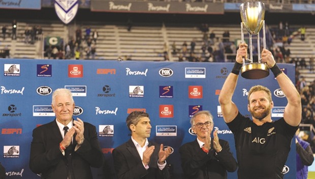 All Blacks captain Kieran Read (R) holds up the Rugby Championship trophy after defeating Argentinau2019s Los Pumas and win the tournament, at Jose Amalfitani stadium in Buenos Aires, Argentina Saturday.