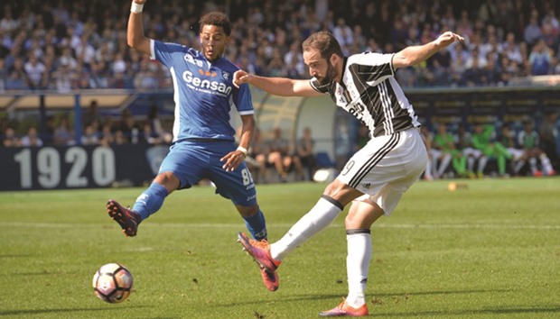 Juventusu2019 Gonzalo Higuain (right) vies for the ball with Empoliu2019s Andres Tello during the Italian Serie A match yesterday. (AFP)