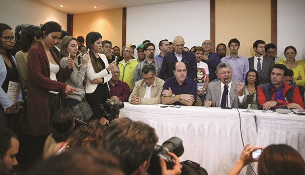 Henry Ramos Allup, president of the National Assembly and deputy of the Venezuelan coalition of opposition parties MUD, speaking at a news conference, next to Venezuelan opposition leader and Governor of Miranda state Henrique Capriles in Caracas on Friday.