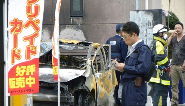Policemen and firefighters investigate a parking lot after an explosion in Utsunomiya, some 100 kilometres north of Tokyo