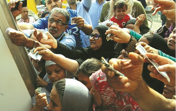 Egyptians gather to buy subsidised sugar from a government truck after a shortage in retail stores across the country in Cairo on October 14. Egyptu2019s inflation is at seven-year-highs, near 14%, as a foreign exchange shortage and a hike in customs duties bite hard in a country that imports everything from sugar to luxury cars.