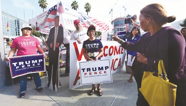 A woman lecturing Trump supporters as volunteers and supporters of Republican presidential candidate Donald Trump and Democratic presidential candidate Hillary Clinton were on hand outside the Los Angeles Convention Center to greet and help recruit new voters following their Naturalisation Ceremony  in Los Angeles, California, last week.
