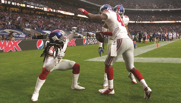 New York Giantsu2019 Dominique Rodgers Cromartie (right) celebrates an interception with Janoris Jenkins during the NFL International Series match against Los Angeles Rams at Twickenham Stadium in London, England, yesterday. (Reuters)
