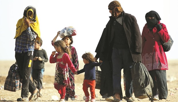 Iraqi refugees who fled Mosul arrive in the desert area of Rajam al-Saliba on the Iraq-Syria border south of al-Hol in Syriau2019s Hassakeh province on Saturday.