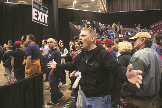 A supporter of Republican presidential nominee Donald Trump yells at members of the media after a campaign event at the International Exposition Center in Cleveland, Ohio.