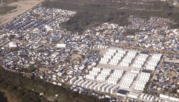 An aerial view shows white containers, tents and makeshift shelters on the eve of the evacuation and dismantlement of the u2018Jungleu2019 migrant camp in Calais.
