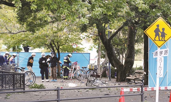 Police officers and firefighters are seen at the site of an explosion in Utsunomiya, in this photo taken by Kyodo.