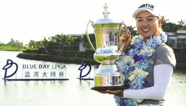 Minjee Lee of Australia poses with her trophy after winning the Blue Bay LPGA tournament at Jian Lake Blue Bay Golf Course in Sanya on Chinau2019s Hainan Island yesterday. (AFP)