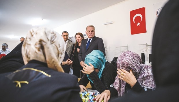 French Foreign Minister Jean-Marc Ayrault visits a refugee camp in the Kilis district of Gaziantep, southeastern Turkey, yesterday.  Franceu2019s foreign minister urged the international community to u201cdo everythingu201d to end the u201cmassacreu201d in the Syrian city of Aleppo after fighting resumed following a 72-hour truce declared by Damascus ally Russia.