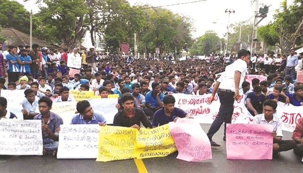 Students take part in a sit-in protest demanding justice over the death of two university students in Jaffna yesterday.