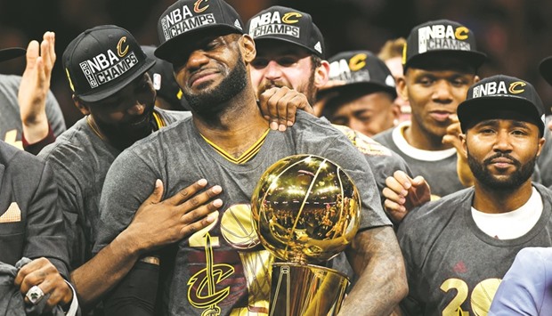 File picture of Cleveland Cavaliersu2019 LeBron James (23) being congratulated by his teammates as he holds the Larry Ou2019Brien Trophy after defeating the Golden State Warriors in Game 7 of the 2016 NBA Finals.