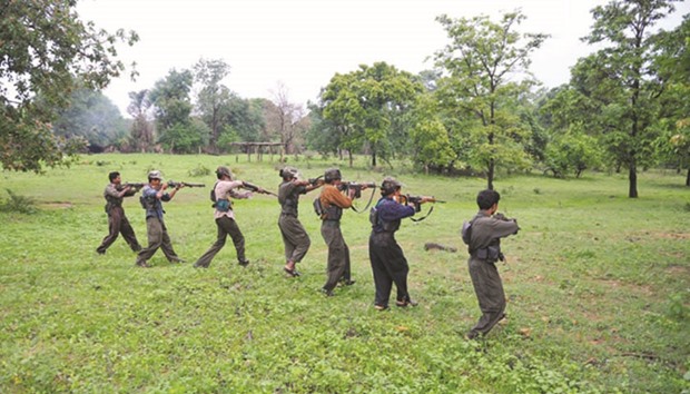 A group of Maoists readying their weapons as they take part in a training camp in a forested area of Bijapur district in Chhattisgarh. Police yesterday killed at least 24 rebels in a shoot-out on the border between Odisha and Andhra Pradesh.