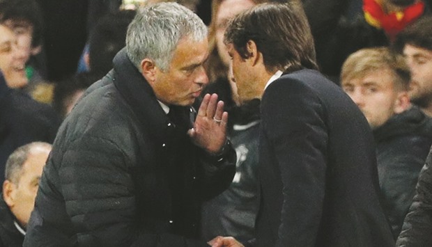 Manchester United manager Jose Mourinho and Chelsea manager Antonio Conte at the end of their EPL match on Sunday. (Reuters)