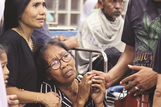 Relatives of a victim injured in a bombing react at a hospital in the southern Thai province of Pattani yesterday.