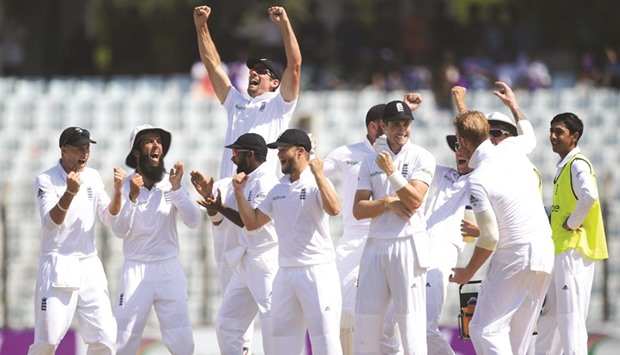 England players celebrate after their win over Bangladesh in the first Test at Zahur Ahmed Chowdhury Cricket Stadium in Chittagong yesterday. ( AFP)