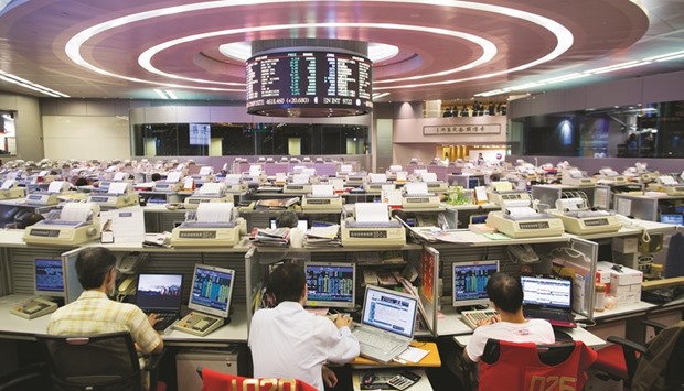 Traders work at the Hong Kong Stock Exchange. The flood of Chinese money into the city before the mainlandu2019s National Day celebrations in early October has slowed to a trickle since traders returned from the week-long break.