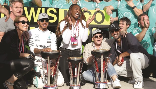 Lewis Hamilton (second left) of Mercedes GP celebrates his US GP win with tennis superstar Venus Williams (centre) and his team in Austin, Texas on Sunday. (AFP)